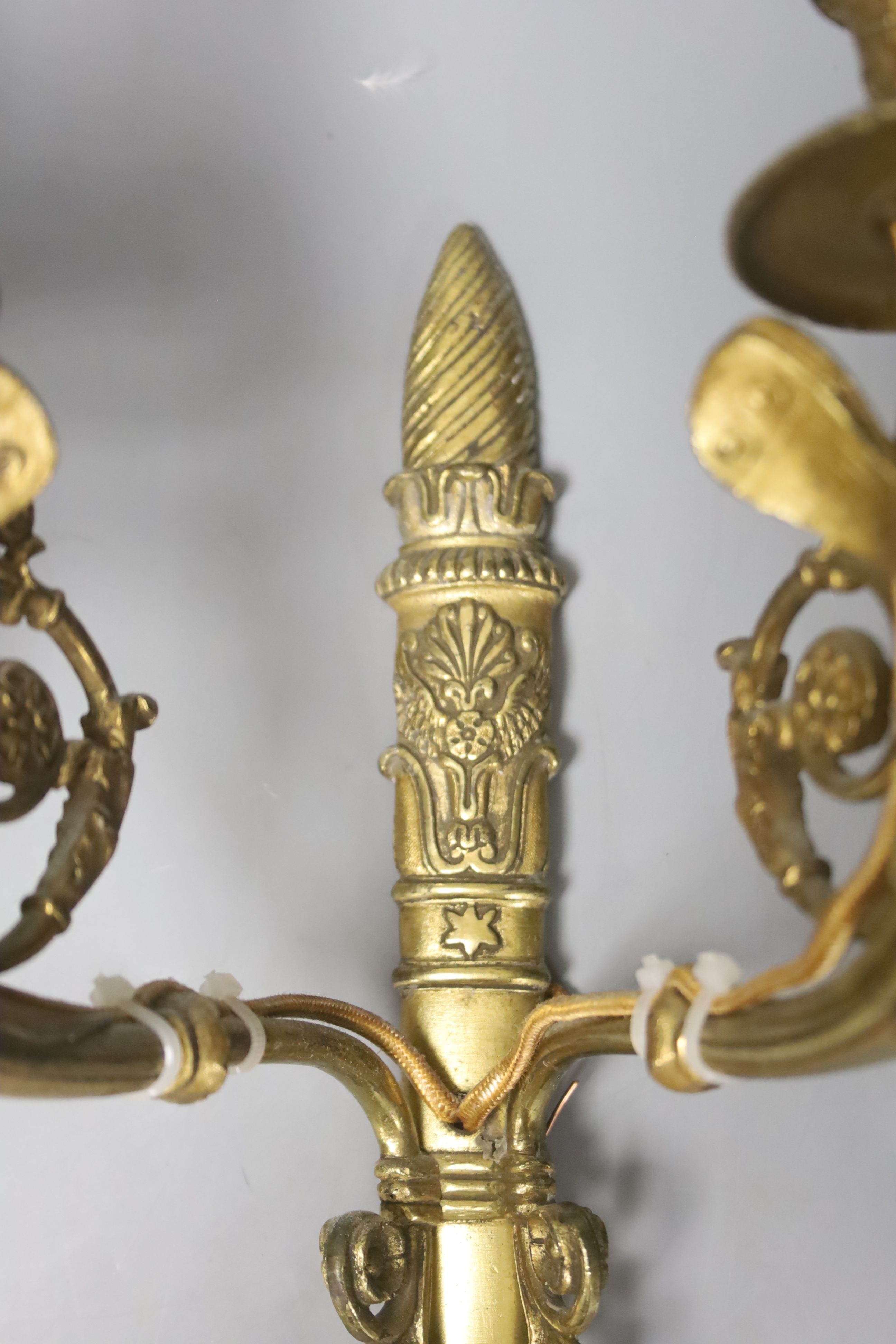 A pair of two branch ormolu wall lights with cherubs, height 42cm